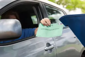 Person in car mailing ballot